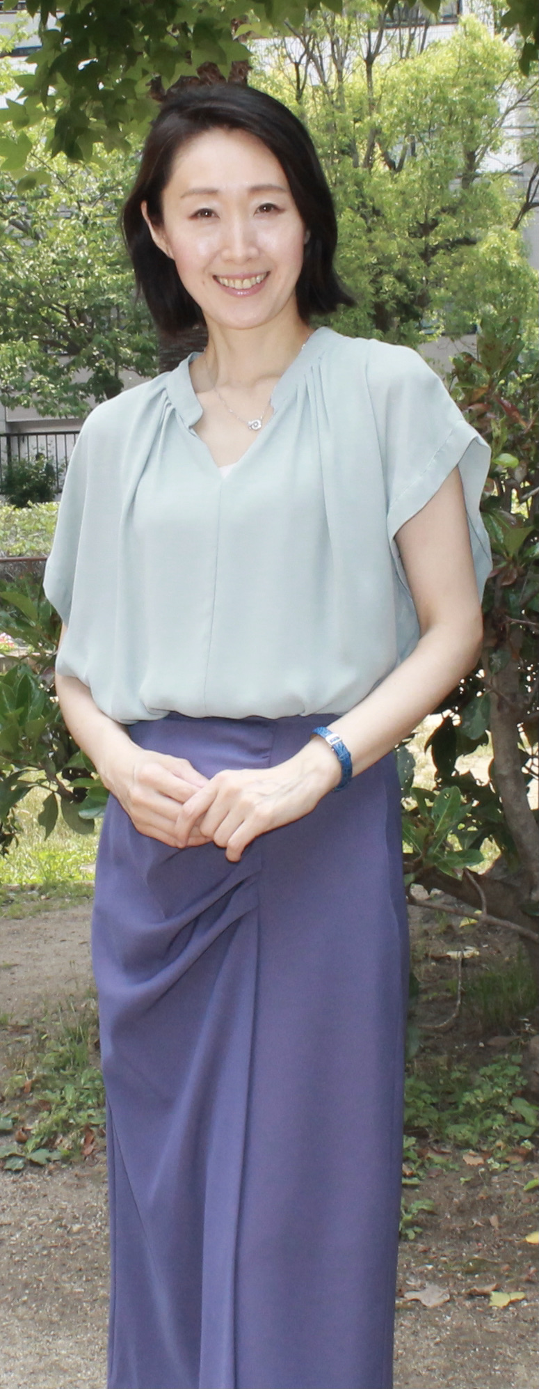 Person smiling while typing a funny username on a laptop keyboard